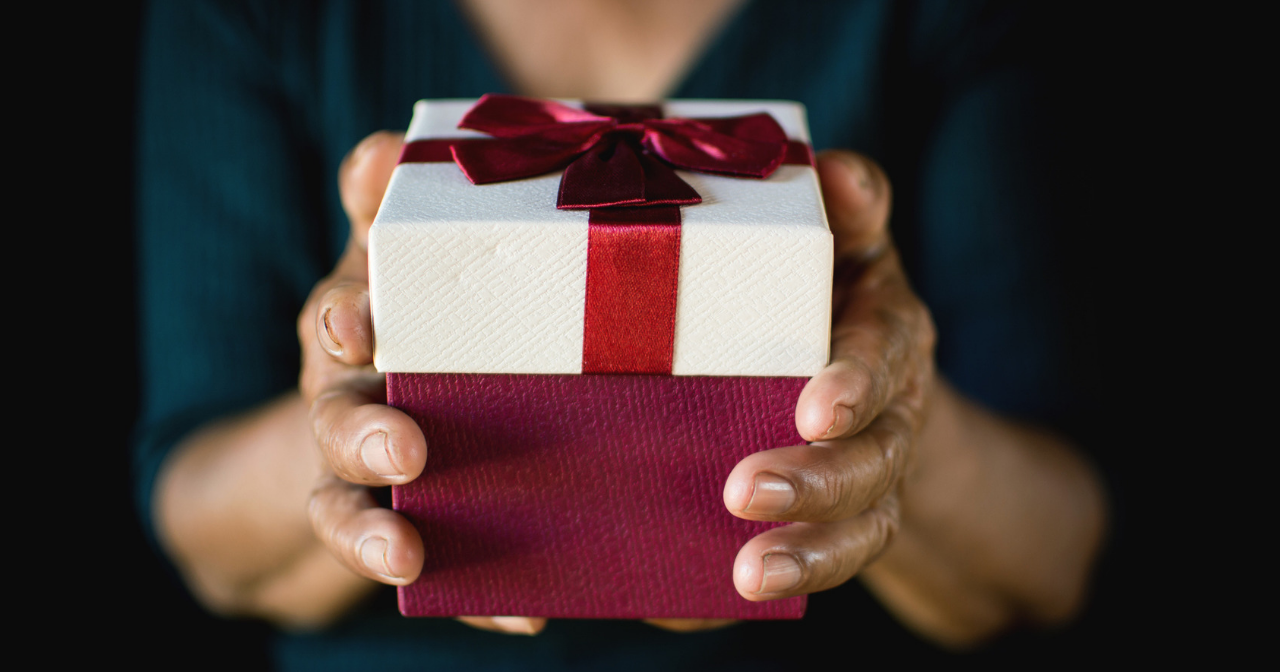 Hands holding a nicely wrapped present. 