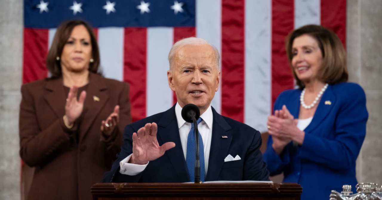 President Biden gives his first State of the Union address while VP Harris and Speaker of the House Pelosi stand and clap behind him. 
