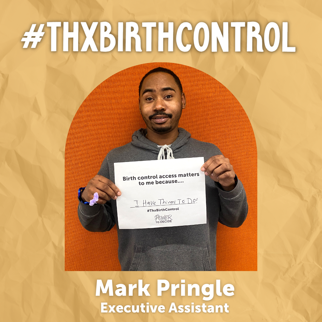 A Power to Decide Staffer holds a sign with their reason for saying #ThxBirthControl.