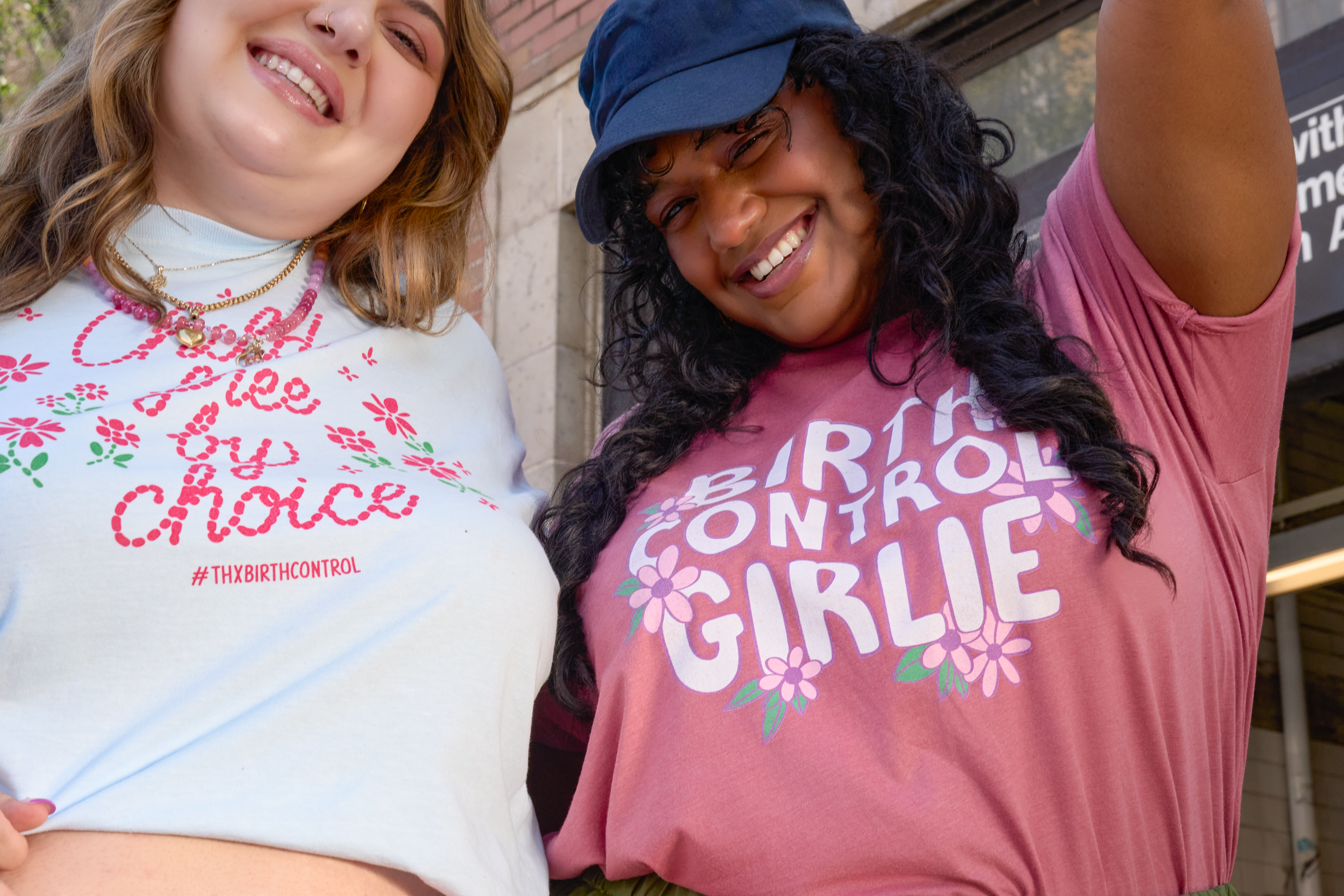 Two people wearing Power to Decide merch