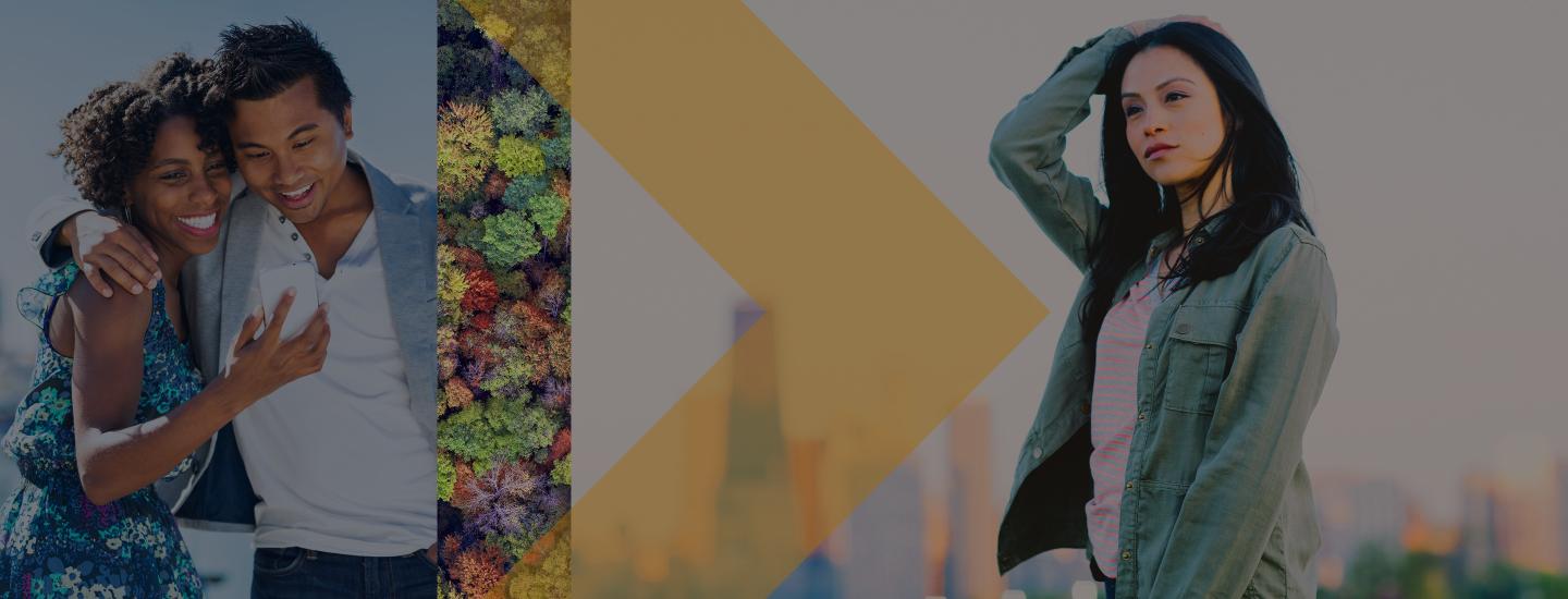 A couple hugs on a beach and a woman runs her hand through her hair