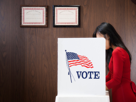 A woman voting in a booth