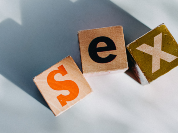 Three wooden blocks with letters on them spell out sex. 