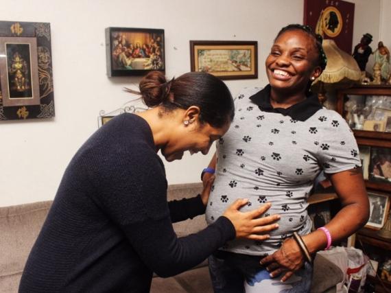 A provider and patient of Mamatoto Village laugh together. 