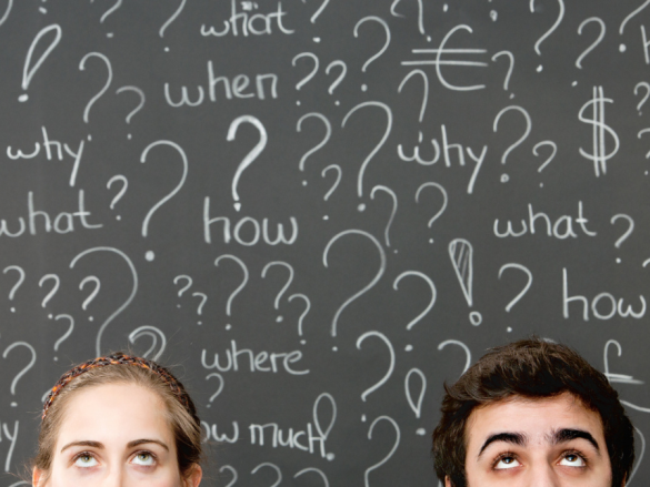 Two faces in front of a chalkboard